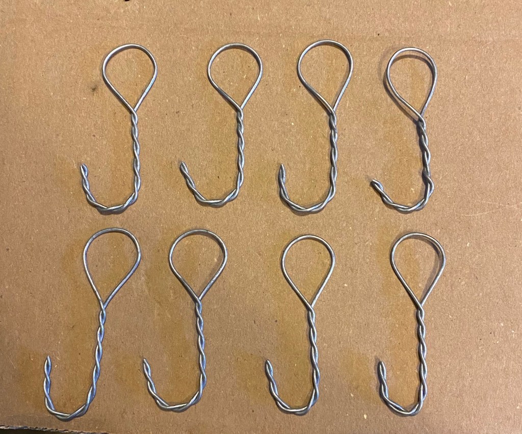 Hooks made from fence repair wire.
Cut & twisted by hand.